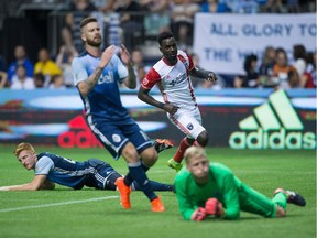 Vancouver Whitecaps' Tim Parker, back left, David Edgar and goalkeeper David Ousted, front right, react as San Jose Earthquakes' Simon Dawkins, back right, watches his shot enter the net for a goal during the second half of an MLS soccer game in Vancouver, B.C., on Friday August 12, 2016.