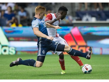 San Jose Earthquakes' Simon Dawkins, back, connects with the ball for a goal as Vancouver Whitecaps' Tim Parker defends during the second half of an MLS soccer game in Vancouver, B.C., on Friday August 12, 2016.