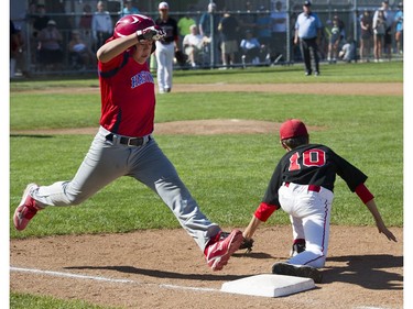 Alberta's Southwest Little league #10 Shaye McTavish tags Hastings Community Little League #11 Aaron Mak out at first base in a semi final game at the Canadian Little League Championships, Vancouver, August 12 2016.