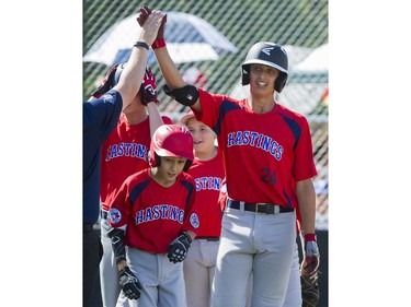 Hastings Community Little League #24 Loreto Siniscalchi  gets a high five from manager Vito Bordigon after his home run hit against the Alberta's Southwest Little league in a semi final game at the Canadian Little League Championships, Vancouver, August 12 2016.