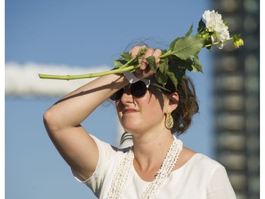 A woman shades her eyes at Le Diner en Blanc at Concord Pacific Place Vancouver, August 18 2016.