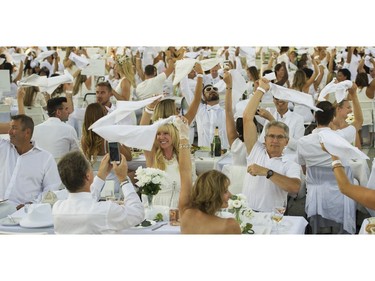 Napkins are waved to signal the start of  Le Diner en Blanc at Concord Pacific Place Vancouver, August 18 2016.