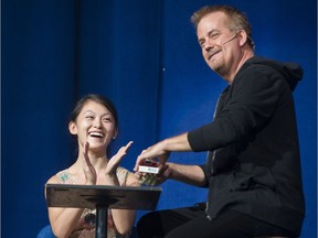 Murray Hatfield performs a card trick with a member of the audience at UNBELIEVABLE, a magical experience at 2016 Fair at the PNE Vancouver, August 20 2016.