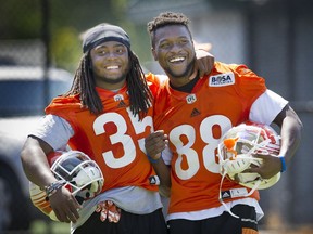 B.C. Lions Shaquille Murray-Lawrence (left) and Shaquille Johnson joke around during practice this week at the CFL team’s training facility in Surrey.
