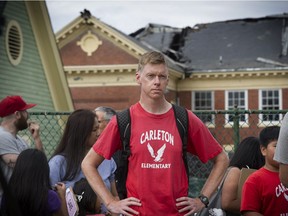 Teacher Scott Macdonald outside fire damaged Sir Guy Carleton Elementary. Students and parents joined forces Sunday in a petition drive to save the school, which was already under threat of closure.