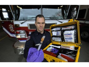 Vancouver Firefighter Jonathan Gormick demonstrates naloxone kit to help combat drug overdose victims in Vancouver on February 10, 2016.