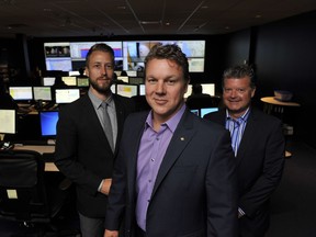 Ashley Cooper, CEO of Paladin Security (centre), with vice-president Chad Kalyk (left) and Scott Ackles, the vice-president of sales and marketing, meet at their office in Burnaby.