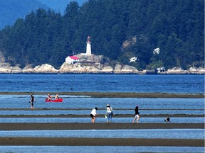 Beach goers enjoy the sunshine at low tide at Spanish Banks. (Nick Procaylo/PNG)