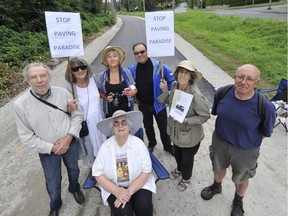 From left: Mark Battersby, Gail Davidson, Elvira Lount, Adrian Levy, Grace Woo and David Fink. Sitting is Diana Davidson. The residents at Maple Crescent and the Arbutus Corridor on Wednesday in Vancouver are upset that the corridor is being temporarily paved. Arlen Redekop/PNG