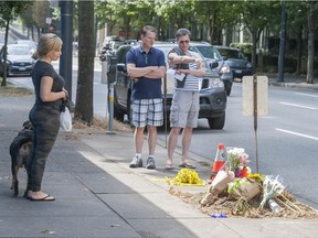 Flowers placed at the scene of a double-fatal car accident that happened Monday at the corner of Davie and Seymour Streets in Vancouver, Tuesday afternoon, August 30, 2016.