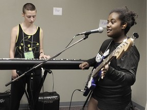 VANCOUVER, BC., July 27, 2016 -- Keyboardist Rozz Barrett in action with bassist Perla Galvan during Rock Camp classes, a yearly camp for girls aged 8-18 to learn how to play instruments, write songs and perform for an audience, in Vancouver, BC., July 27, 2016. (Nick Procaylo/PNG) 00044126B [PNG Merlin Archive]