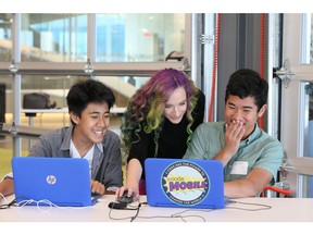 Instructor Nat Cooper helps out some students at a recent YMCA coding youth camp hosted by Microsoft in downtown Vancouver.