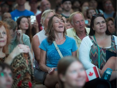A woman sings along during a viewing party for the final stop in Kingston, Ont., of a 10-city national concert tour by The Tragically Hip, in Vancouver, B.C., on Saturday August 20, 2016. Lead singer Gord Downie announced earlier this year that he was diagnosed with an incurable form of brain cancer.