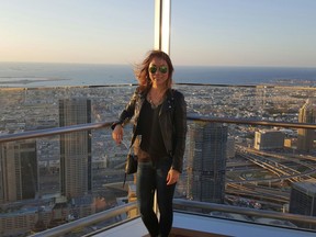 Liana Lau stands at the top of the world’s tallest skyscraper during a work trip in Dubai