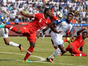 Honduras' Romell Quioto (2nd-R) vies for the ball with Canada's Doneil Henry (L) during their 2018 FIFA World Cup qualifiers football match in the Olimpico Metropolitano stadium in San Pedro Sula, Honduras on September 2, 2016. / AFP PHOTO / STRSTR/AFP/Getty Images ORG XMIT: 748