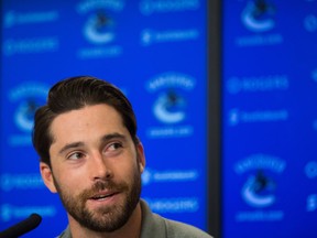 Vancouver Canucks' defenceman Erik Gudbranson, who was acquired from the Florida Panthers in the off-season, answers questions during a news conference ahead of the NHL hockey team's training camp, in Vancouver, B.C., on Thursday September 22, 2016. THE CANADIAN PRESS/Darryl Dyck ORG XMIT: VCRD107