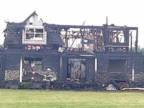 A Langley Township firefighter checked out the ruins of a rural Langley home destroyed by fire the night of Sept. 4.
