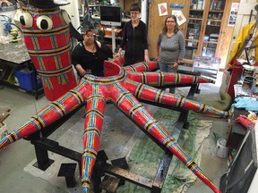 Artist Cat L'Hirondelle (left) plans to place Squid Vicious, a giant four-metre-wide papier mache squid, on the roof of her east Vancouver studio this Saturday. L'Hirondelle, who is disabled, got some help in making Squid Vicious from assistants Jessica Berg (centre) and Holly Woodcock (right).