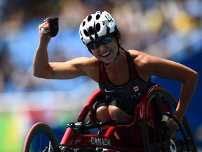 Michelle Stilwell celebrates after winning the 100M T52 wheelchair race at the Paralympic Games in Rio on Sept. 17, 2016. She is wrestling with juggling her athletic and political careers.