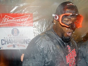 ‘Big Papi’ pops off — with beer and bubbly, that is: David Ortiz of the Boston Red Sox celebrates after clinching the American League East Division title on Wednesday in the visiting team’s clubhouse at New York’s Yankee Stadium.