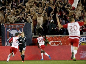 New York Red Bulls forward Bradley Wright-Phillips (99) celebrates after scoring a goal against D.C. United during the second half of an MLS playoff soccer match, Sunday, Nov. 8, 2015, in Harrison, N.J. The Red Bulls won 1-0.