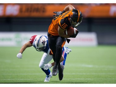 B.C. Lions' Bryan Burnham, front, gets away from Montreal Alouettes' Chip Cox to run the ball in for a touchdown that was called back due to an illegal block during the second half of a CFL football game in Vancouver, B.C., on Friday September 9, 2016.