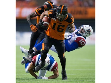 B.C. Lions' Bryan Burnham, front, runs the ball in for a touchdown that was called back due to an illegal block by Chris Rainey, back left, on Montreal Alouettes' Marc-Olivier Brouillette (10) during the second half of a CFL football game in Vancouver, B.C., on Friday September 9, 2016.