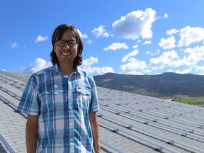 Chief Aaron Sam stands atop an 85.8-kilowatt solar panel system recently installed on the roof of the Lower Nicola Indian Band's school.