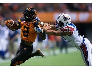 B.C. Lions' Chris Rainey, left, is brought down by Montreal Alouettes' Winston Venable, who was penalized for an illegal tackle, as he tries to run the ball into the end zone during the second half of a CFL football game in Vancouver, B.C., on Friday September 9, 2016.