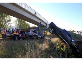 Tow-truck crews remove pickup that crashed into a ditch near Uptown shopping centre on Vancouver Island Thursday.