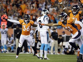 Denver Broncos cornerback Kayvon Webster (left) celebrates a Carolina Panthers missed field goal as Panthers holder Andy Lee looks away after the final play of Thursday’s National Football League season opener in Denver. Expect strong TV numbers after such a tight, climactic contest on opening night.