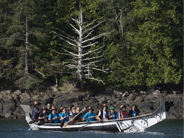 The Duke and Duchess of Cambridge paddle with a group in a traditional canoe in the waters of Haida Gwaii, Friday, Sept. 30, 2016.