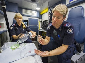 Paramedics Jill, left, and Stefan show the shot of Naloxone and the ventilation bag with which they reverse the effects of a fentanyl overdose.