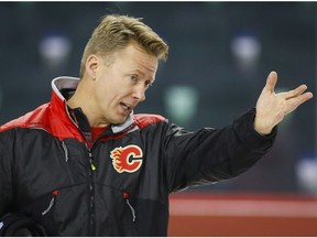 Calgary Flames head coach Glen Gulutzan gives instruction during an on-ice session on the second day of training camp in Calgary, Friday, Sept. 23, 2016.