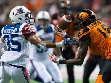 B.C. Lions' Geraldo Boldewijn, right, bobbles a pass and fails to make the reception as Montreal Alouettes' Greg Henderson watches during the second half of a CFL football game in Vancouver, B.C., on Friday September 9, 2016.