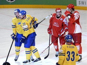 Sweden's Daniel Sedin hugs linemate Loui Eriksson (far left) as Henrik Sedin (bottom right) comes in to join them, after scoring against Denmark at the 2013 world hockey championships in Stockholm. One benefit of this month’s World Cup is it will give the Sedin twins a head-start with their prospective new Canucks linemate in Eriksson.