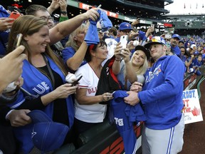 So who then, again, was the home team? Toronto Blue Jays third baseman Josh Donaldson (right) pose for a photo with one of the thousands of Jays fans — most of them British Columbians — who descended on Seattle’s Safeco Field earlier this week for the Blue Jays-Mariners series.