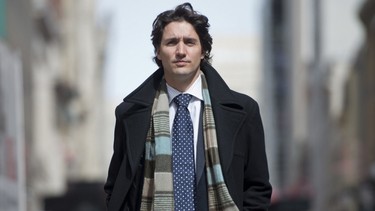 Trudeau sports open coat, scarf and tie.