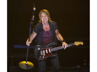 Keith Urban points his microphone to the crowd as they sing with him as he performs at Rogers arena during his Ripcord World Tour Vancouver, September 10 2016.