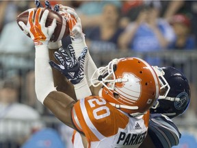 BC Lions defensive back Keynan Parker (20) gets knocked down in front of Toronto Argonauts wide receiver Tori Gurley to prevent a touchdown during second half CFL football action, in Toronto on Wednesday, August 31, 2016.