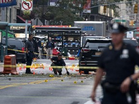 Crime scene investigators work Sunday, Sept. 18, 2016, at the scene of Saturday's explosion in Manhattan's Chelsea neighborhood, in New York.