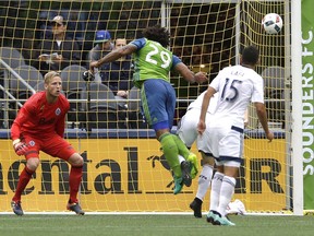 Vancouver Whitecaps goalkeeper David Ousted, left, watches as a header shot by Seattle Sounders defender Roman Torres (29) goes wide in the first half of an MLS soccer match, Saturday, Sept. 17, 2016, in Seattle. (AP Photo/Ted S. Warren) ORG XMIT: WATW104