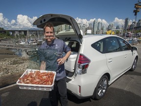 Four Seasons Head Chef Ned Bell with prawns and Prius at False Creek Fisherman's Wharf in Vancouver.