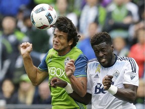 Sounders forward Nelson Valdez, left, goes for a header against Vancouver Whitecaps defender Jordan Smith in the second half Saturday in Seattle. The Sounders beat the Caps 1-0.