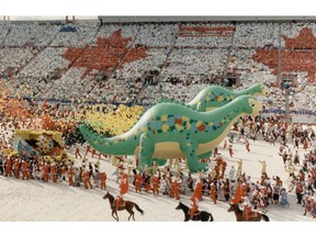 Olympics Launched: Giant inflated dinosaurs, horses and thousands of cheering people joined together to give a distinct Canadian and Albertan flavor to the official Games opening in Calgary. Date: February 14, 1988 Photo: Herald file photo *Calgary Herald Merlin Archive* [PNG Merlin Archive]