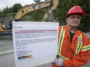 David Britton is a heavy-duty mechanic who has won a discriminatory action complaint against former employee SNC-Lavalin. Britton stands outside the Evergreen Line tunnel work site on Wednesday, Sept. 7, 2016, with a key page from the ruling.