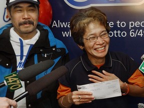 Enone Rosas, with her husband Pacito, picking up their Lotto 6/49 cheque for $4.163 million in 2007. She later loaned $600,000 to a friend, Isabel Toca, who has refused to repay the money. Now a B.C. Supreme Court judge says it's too late for Rosas to collect.