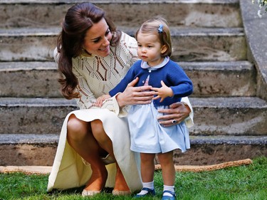 Britain's Catherine, Duchess of Cambridge, speaks to Princess Charlotte (R) as they arrive at a children's party at Government House in Victoria, Thursday, Sept.29, 2016.