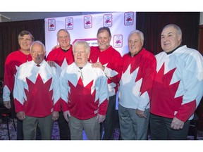 Team Canada 1972 players Serge Savard, left, Yvan Cournoyer, Ken Dryden, Pat Stapleton, Peter Mahovolich, Phil Esposito and Guy Lapointe, right, pose for photos at a news conference, in Montreal on Tuesday, Feb. 9, 2016. Members of the 1972 Team Canada will tour the country in September to talk about the historic 1972 hockey series against the Soviet Union.