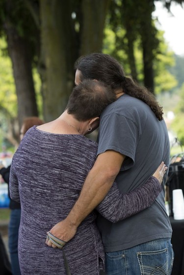 BURLINGTON, WA - SEPTEMBER 24:  Michelle Kinhart (left) and Mike Berryman hug each other during a community gathering at Maiben Park on September 24, 2016 in Burlington, Washington. "We could hear the helicopter circling the house all night," said Kinhart. "It was terrifying," said Berryman.  Five people were killed last night when a gunman opened fire in the Cascade Mall.